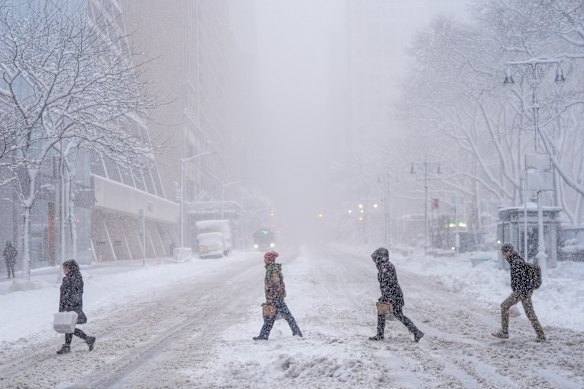 Pedestrians cross 42nd street near Bryant Park, New York City on Monday.