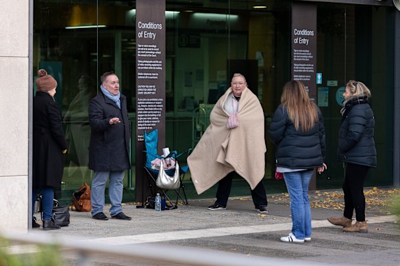 Members of the public line up outside the court in the early hours of the morning.