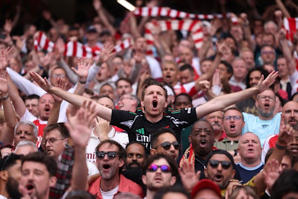 A fan of Arsenal chants inside the stadium during the Premier League match between Arsenal and Leeds in London