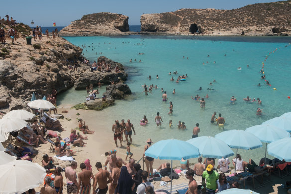 Tourists at Blue Lagoon in Comio, Malta, in late July. The country of about half a million people has vaccinated 90 per cent of its adult population.