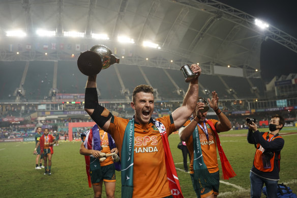 Australia’s Nick Malouf holding the winning trophy celebrates after winning the Hong Kong Sevens rugby tournament against Fiji .