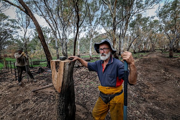 Neil Devanny and Jayme Sexton rebuilding a fence on Neil’s property.