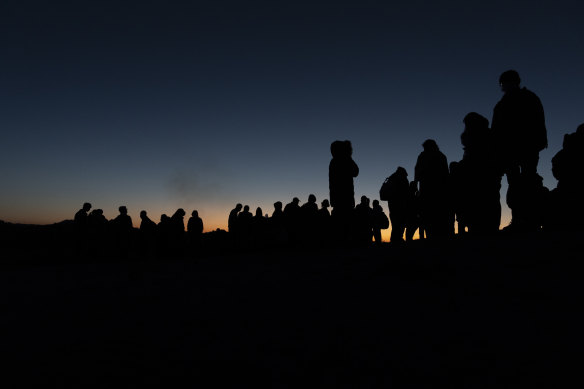 Chinese migrants wait to be processed after crossing the US-Mexico border near Jacumba Hot Springs, California in May.