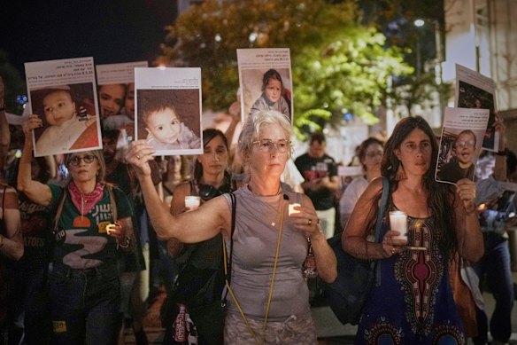 Protesters hold pictures of Palestinian children killed during Israel’s military operation in a protest demanding the end of the war in Tel Aviv, Israel on Saturday.