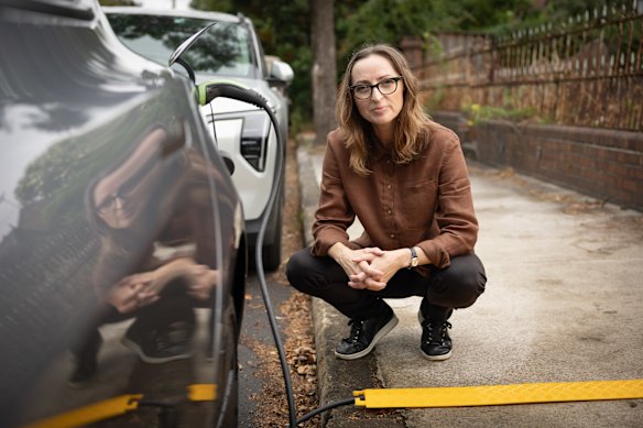 Electrification and EV advocate Sarah Aubrey is part of the Inner West Council trial using cable covers to charge an EV on the street.