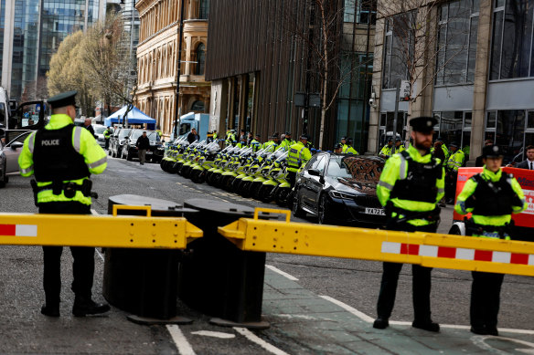 Exposed: Northern Ireland police officers stand guard outside the Grand Central Hotel, when US President Joe Biden visited in April.