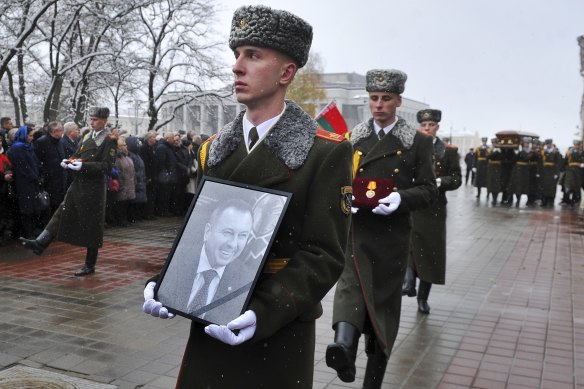 Members of the Honour Guard carry a portrait, awards and the coffin with the body of Belarusian Foreign Minister Vladimir Makei during his farewell ceremony at the Central House of Officers in Minsk, Belarus.