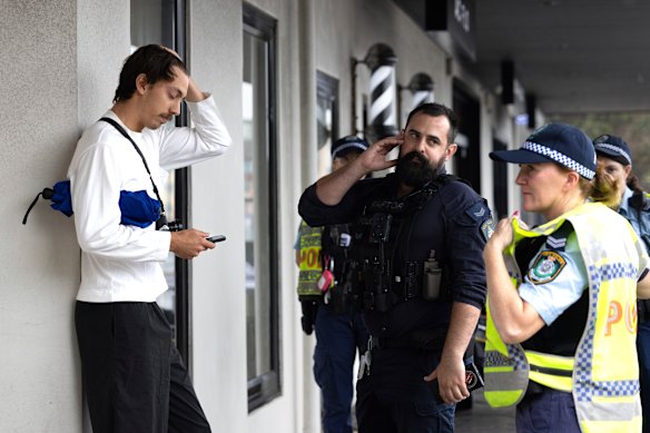 Police speak to a protester in Bondi during Herzog’s visit. 