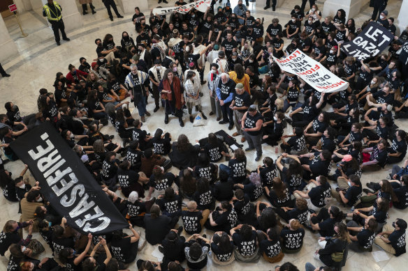 Demonstrators sit inside the Canon House office building calling on Congress for an immediate ceasefire and for humanitarian assistance to be allowed to enter Gaza, during a rally on Capitol Hill.