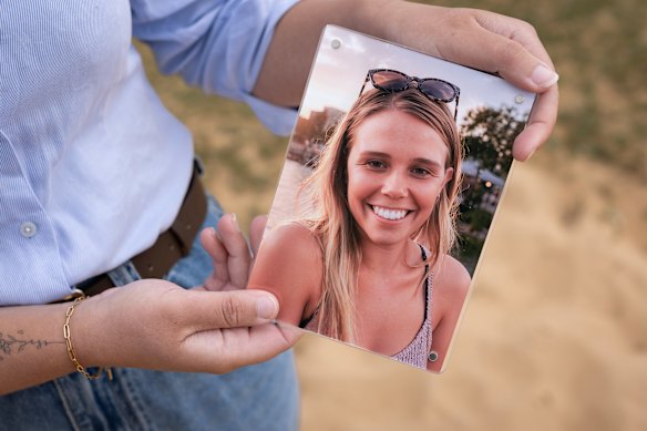Madisson Bowler holds a picture of Meaghan, allegedly murdered by her husband this year.