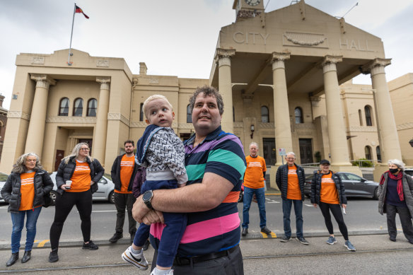 Yarra Residents Collective co-founder Adam Promnitz, with son Xavier, and other residents during a protest outside Richmond Town Hall.
