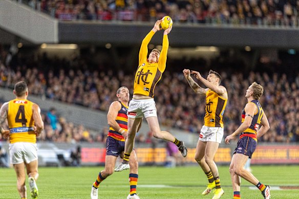 James Sicily of the Hawks flies for a mark.