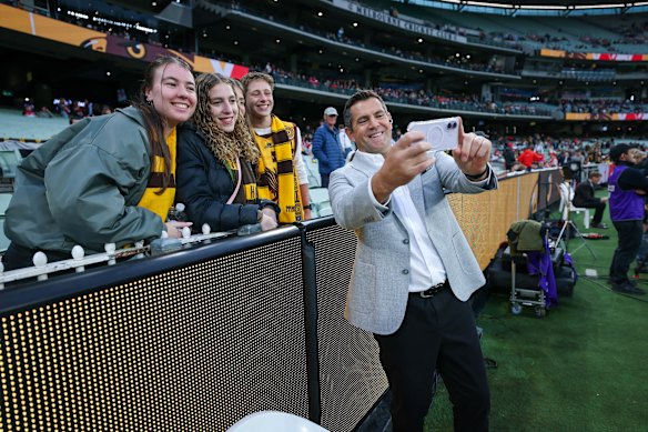 Luke Hodge with fans before the game.
