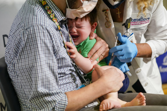One-year old Asher Schwab receives his Moderna COVID shop in the Bronx, New York last month. US officials are relying on vaccinations, instead of mask mandates and restrictions, to curb infections.