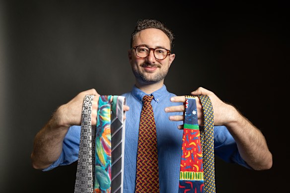 Elias Visontay holding his ties.
