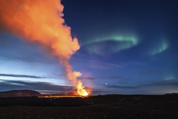 Lava flowing from the volcano was backdropped by the northern lights on March 24.