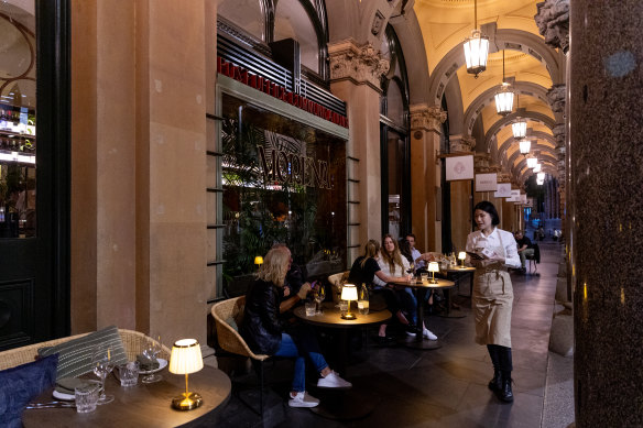 The outdoor portico is fringed with cocktail tables.