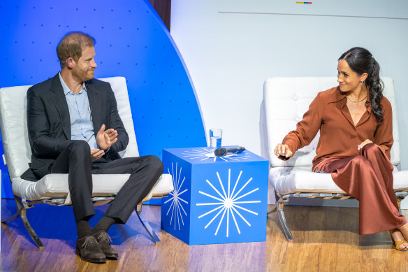 Prince Harry and Meghan speak onstage at EAN University during a visit to Colombia on August.