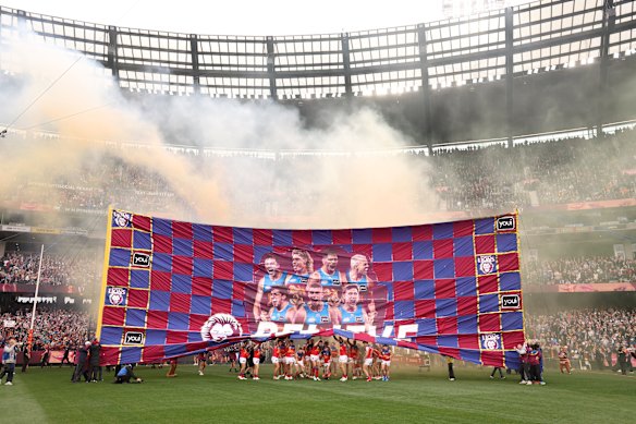 The Lions running through their banner on Saturday.