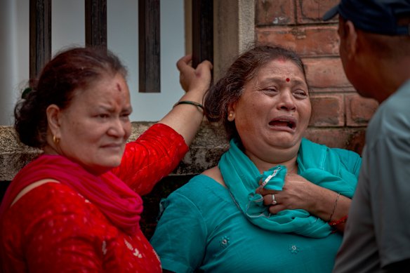 A woman cries outside Maharajgunj Medical Campus, where unidentified bodies recovered from the floods are being taken.