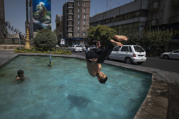 “Feels like” temperature recently reached 70 degrees in Iran. A young boy jumps into a pool to cool down at a square in downtown Tehran.