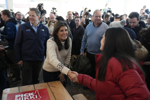 Republican presidential candidate Nikki Haley shakes hands with a diner at the Beach Plum in New Hampshire on Sunday.