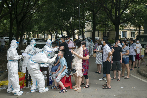 Residents line up to be tested for COVID-19 in Wuhan, China, this month.