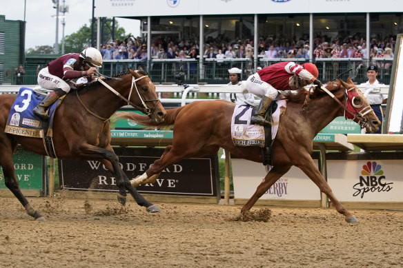Rich Strike (21), with Sonny Leon aboard, beats Epicenter (3), with Joel Rosario aboard, at the finish line to win the 148th running of the Kentucky Derby.