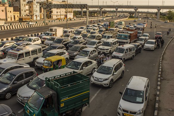 Vehicles driving on a road, after the country relaxed its lockdown restriction in Delhi, India. 