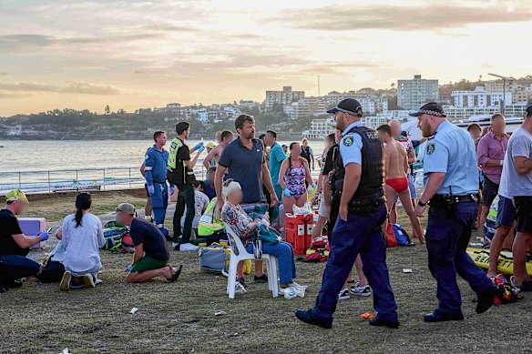 Dr James Otton assists the wounded at Bondi Beach on Sunday in the aftermath of the attack.