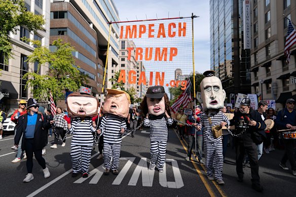 Demonstrators wear costumes and carry signs on the march to the National Mall.