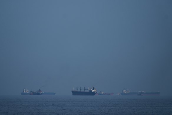 Oil tankers and cargo ships line up in the Strait of Hormuz as seen from Khor Fakkan, United Arab Emirates.