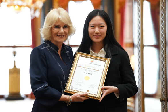 Camilla with Sawooly Li  during a reception for winners of the Queen’s Commonwealth Essay Competition 2022 at Buckingham Palace.