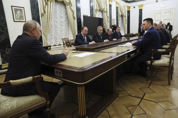 Russian President Vladimir Putin, back to the camera, chairs a Security Council meeting in Moscow, Russia, Monday, June 26, 2023.