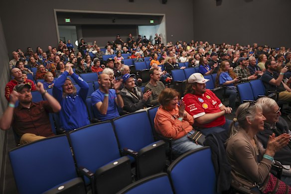 People celebrate as Orion returns during a viewing party at the Museum of Flight in Seattle.