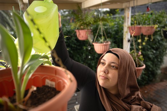 Rania Omar, 26, waters her plants outside her granny flat in Blacktown. She believes that more greenery would help make Western Sydney cooler.