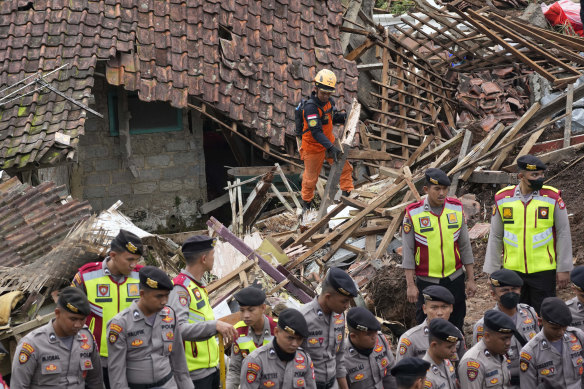 Rescuers search for victims at a village hit by an earthquake-triggered landslide in Cianjur, West Java, Indonesia.