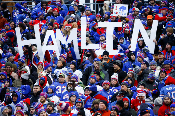 Bills fans hold a sign in support of Damar Hamlin at Orchard Park.