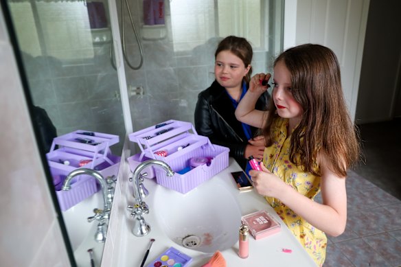 Billie Johnston, 8, applies makeup from Mecca with a friend.