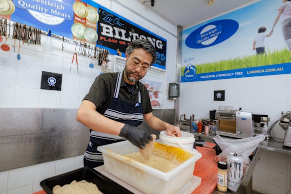 Westleigh Quality Meats owner Sing Zhao prepares veal schnitzel.