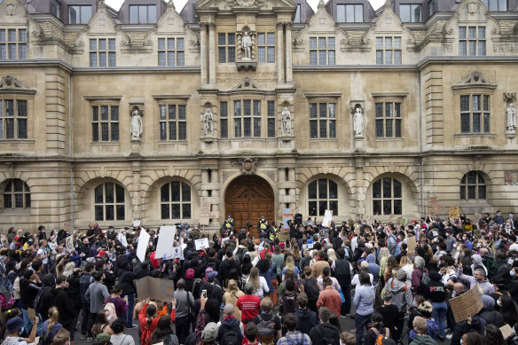 Protesters gather outside Oxford University's Oriel College, demanding the removal of a Cecil Rhodes statue from its facade.