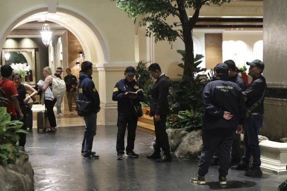 Police gather outside the Grand Hyatt Erawan Hotel in Bangkok, Thailand.