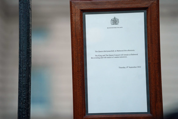A notice is posted by members of royal household staff on the gates of Buckingham Palace announcing the death of Queen Elizabeth II in Balmoral.