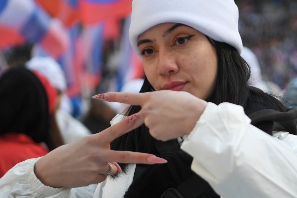 A young woman shows the letter Z, which has become a symbol of the Russian military. 
