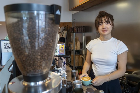 Maggie Li, 27, pours a flat white at Cafe del Volcan in Shanghai.