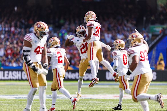 San Francisco 49ers cornerback Upton Stout and safety Marques Sigle celebrate after stopping the LA Rams on the goal line during the NFL game at the MCG.