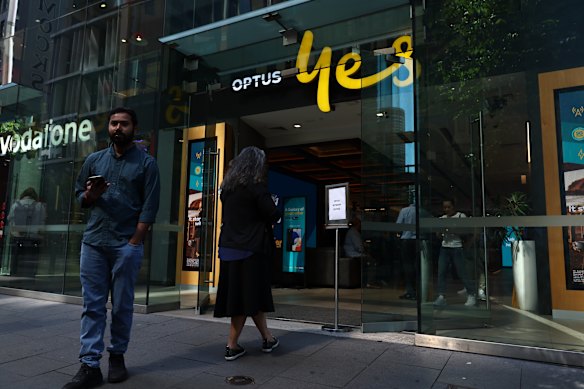 Customers line up outside the Optus store in George Street during the network outage. 