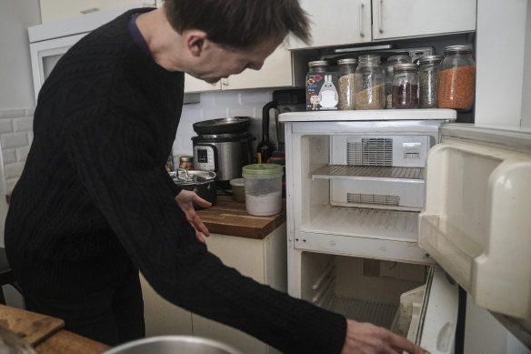 Josh Spodek shows the empty refrigerator he ditched in his New York apartment to support his effort to live sustainably.