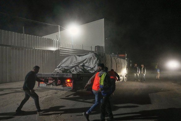 Aid trucks carrying food arrive at a World Food Program warehouse in Zawaida, central Gaza.