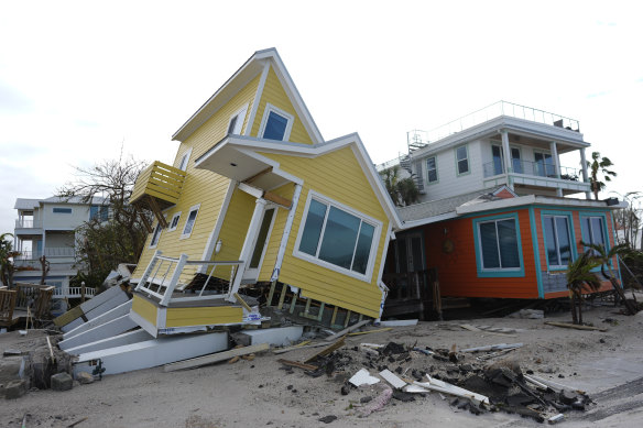 A house lies toppled off its stilts after the passage of Hurricane Milton.